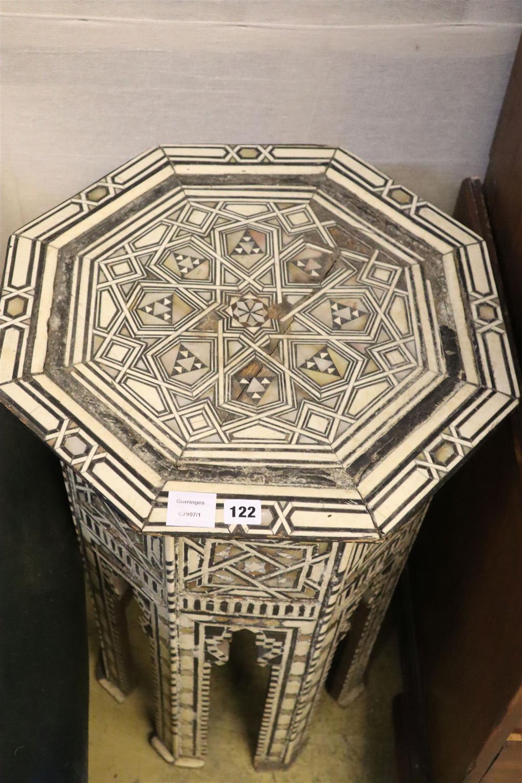 A Middle Eastern octagonal topped ebony and bone inlaid coffee table (damaged), width 49cm, 81cm high